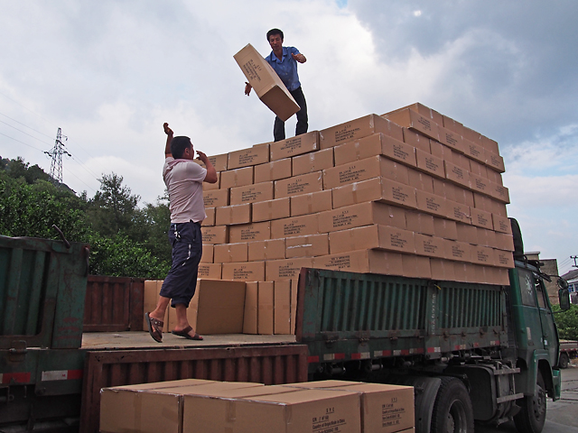 men throwing boxes