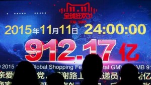 Journalists look at a screen showing total value of goods transacted at Alibaba Group's 11.11 Global shopping festival in Beijing, China, November 12, 2015. REUTERS/Kim Kyung-Hoon
