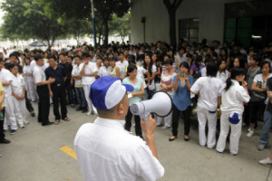 An unidentified manager from the Honda Lock (Guangdong) Co. factory tries to persuade workers to go back to the factory in Zhongshan, Guangdong province, China, on Saturday, June 12, 2010. Workers at the Honda Motor Co. parts maker in southern China remained off the job for a fourth day as conflicts over wages deepen at foreign-owned plants in the world's biggest export economy. Photographer: Qilai Shen/Bloomberg via Getty Images