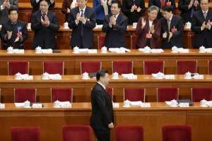 Delegates applaud as China's President Xi Jinping arrives for the opening session of the National People's Congress (NPC) in Beijing