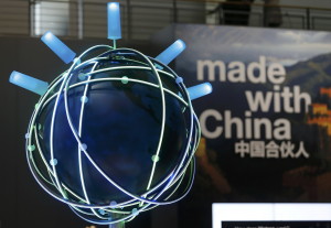 The motto of this year's CeBit trade fair ' Made With China' is seen next to a rotating globe at the IBM booth